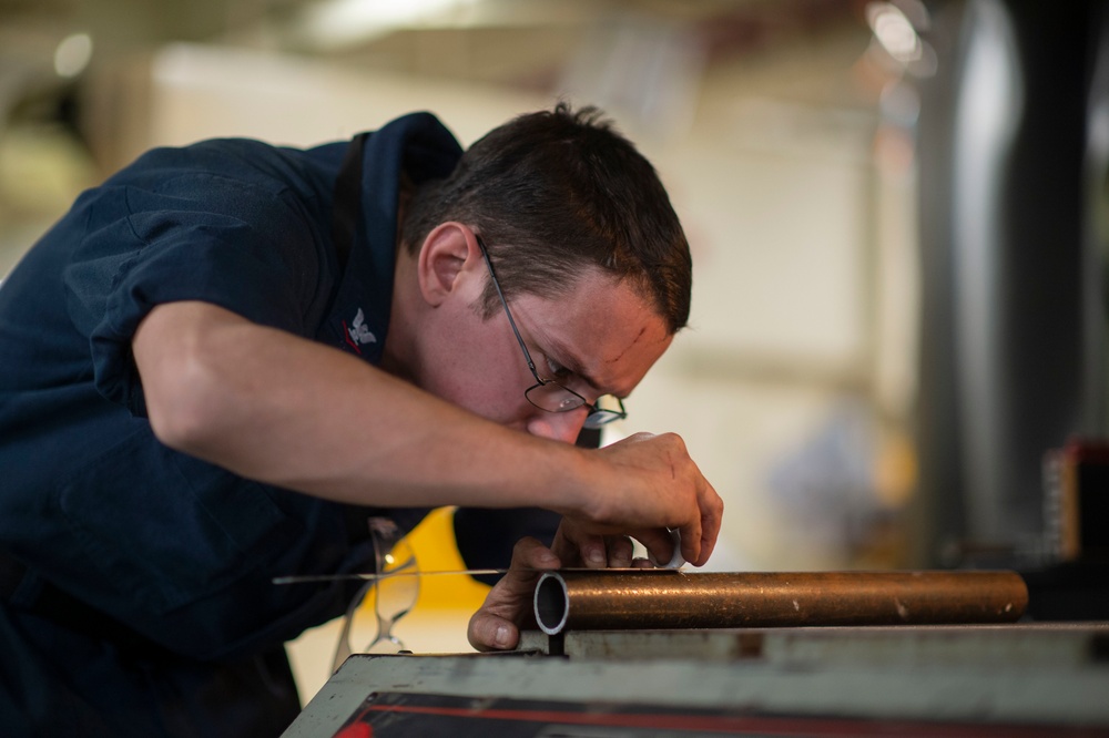 GHWB Sailor Measures Pipe