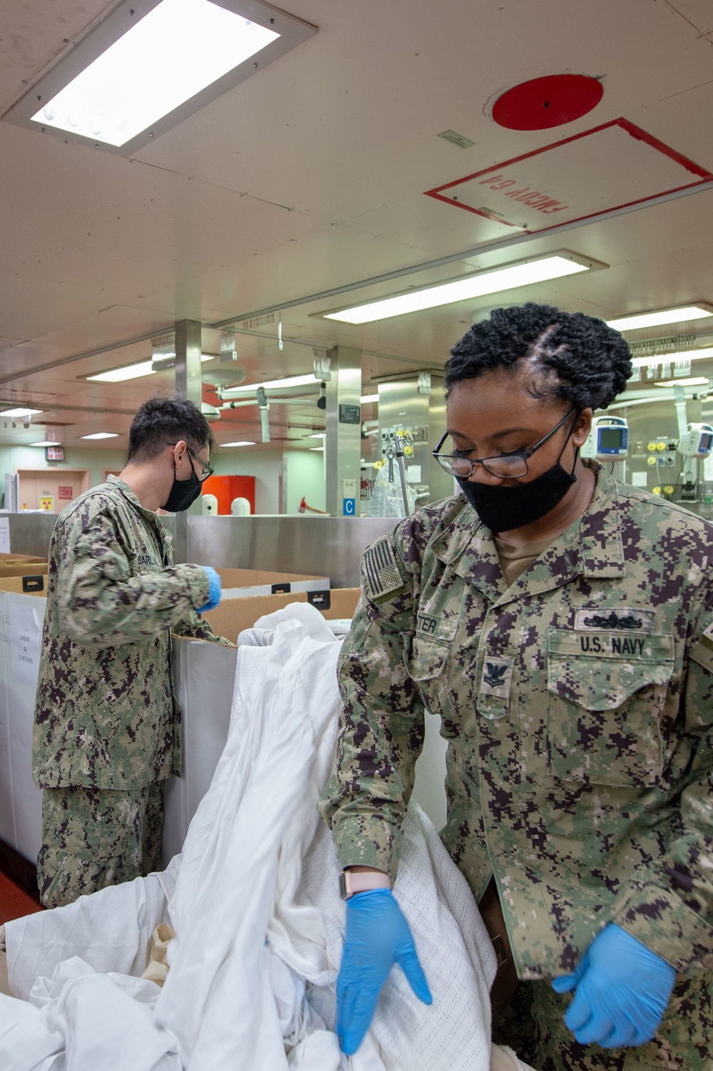 USNS Mercy Sailors Sort Linens