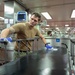 USNS Mercy Sailor Sanitizes Gurneys