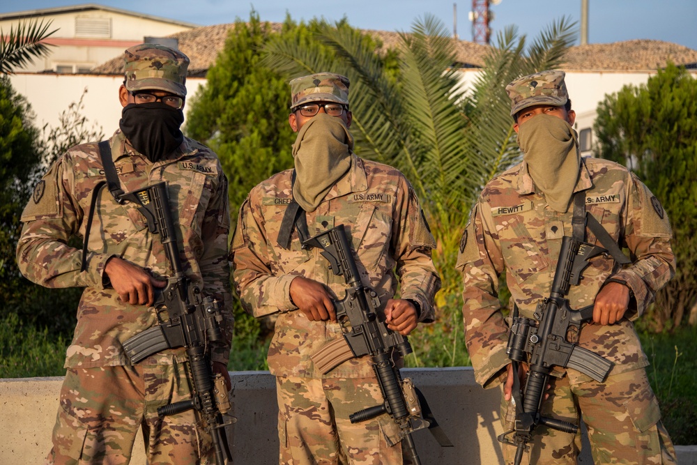 Deployed service members wear improvised face masks