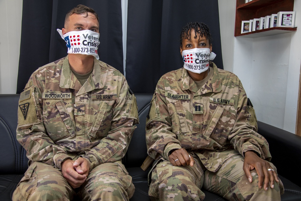 Deployed service members wear improvised face masks