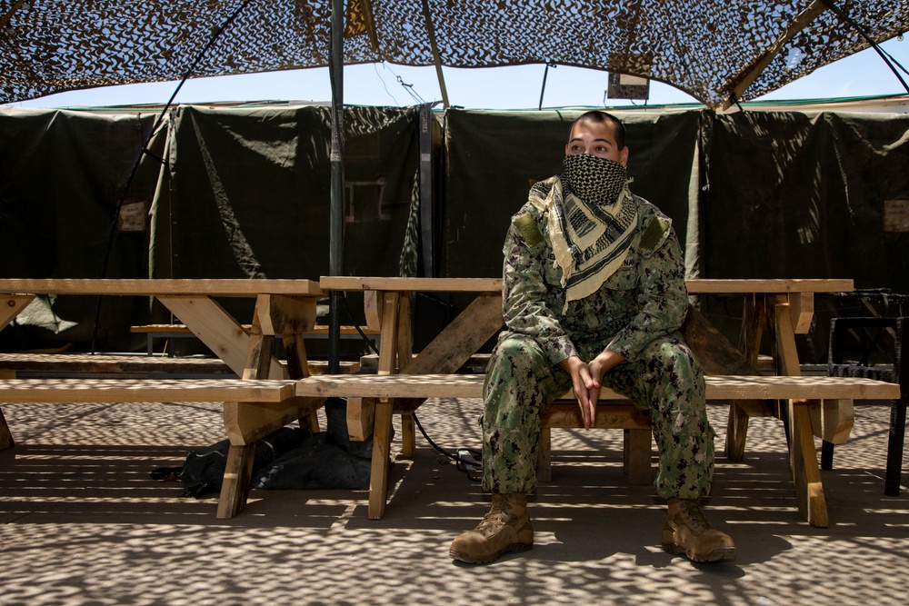 Deployed service members wear improvised face masks