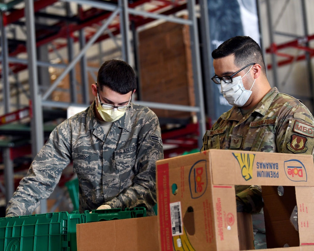 Air National Guardsmen assigned to the 149th Fighter Wing assist local food banks