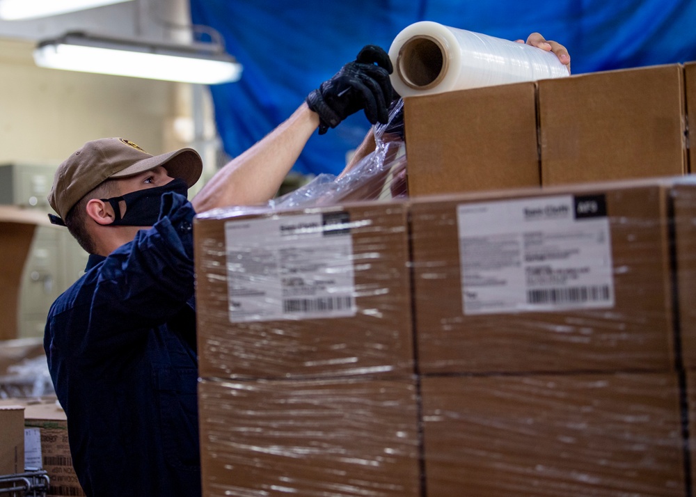 USNS Mercy Sailor Works in Supply Warehouse