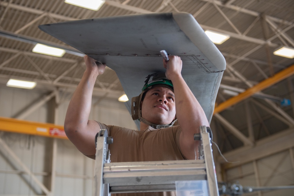 Sailor performs maintenance on MH-60S Sea Hawk