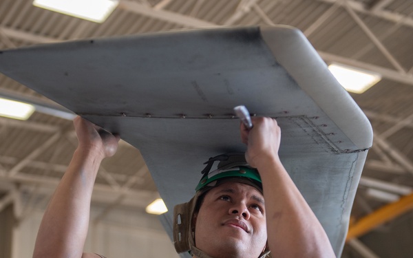 Sailor performs maintenance on MH-60S Sea Hawk