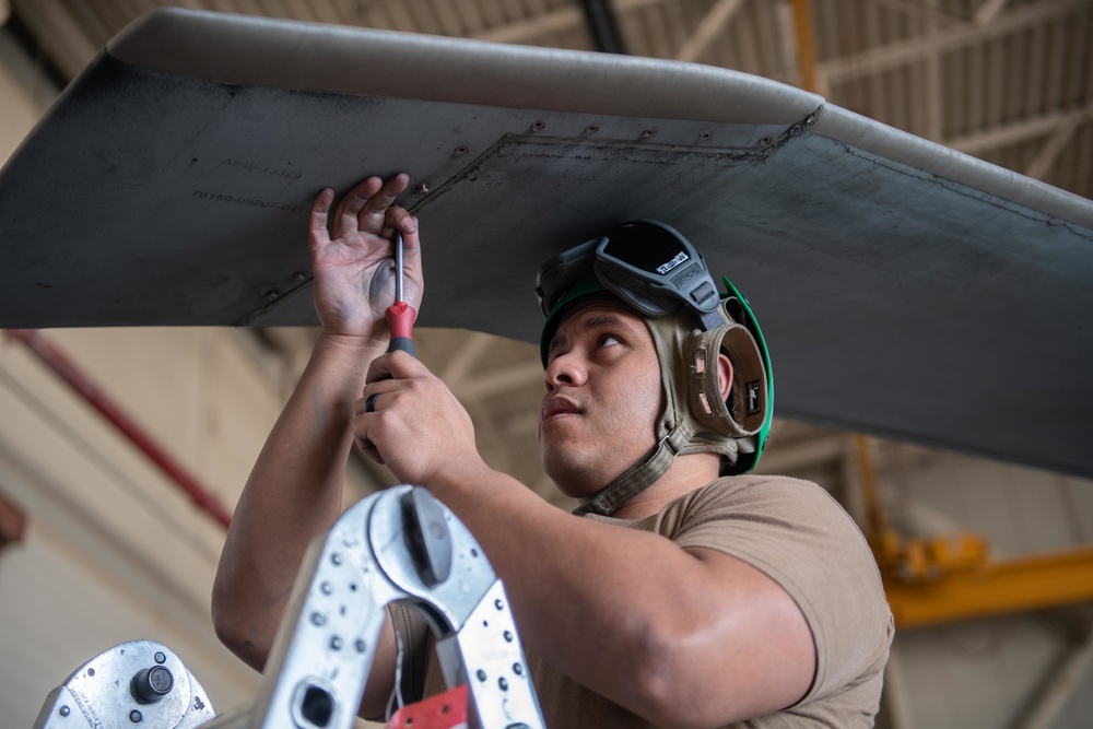 Sailor performs maintenance on MH-60S Sea Hawk