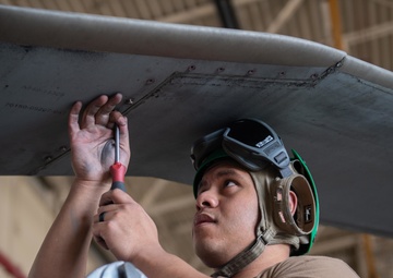 Sailor performs maintenance on MH-60S Sea Hawk