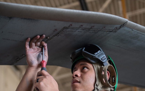 Sailor performs maintenance on MH-60S Sea Hawk