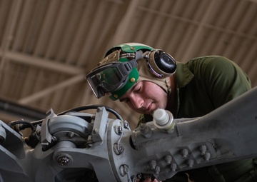 Sailor performs maintenance on MH-60S Sea Hawk