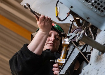Sailor performs maintenance on MH-60S Sea Hawk
