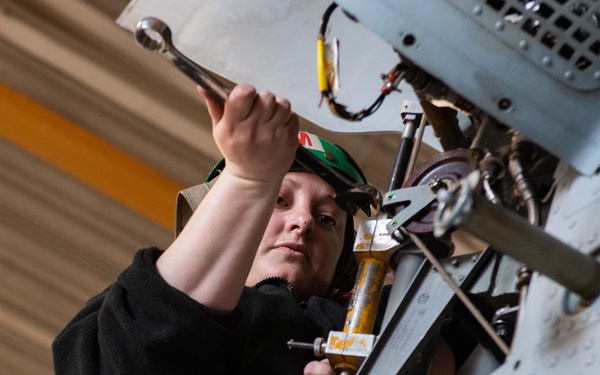 Sailor performs maintenance on MH-60S Sea Hawk