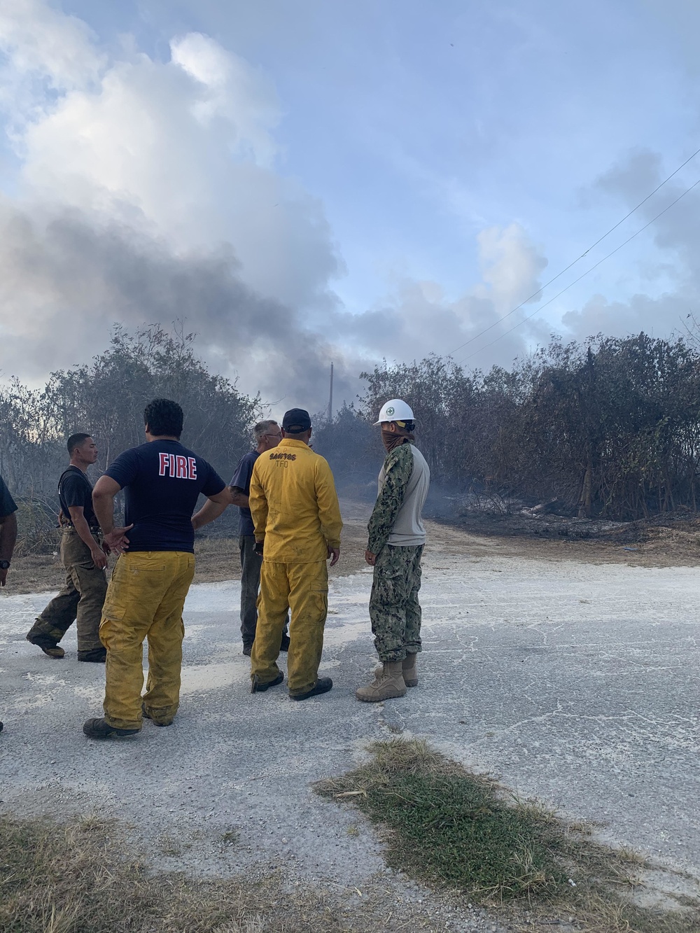 U.S. Navy Seabees with NMCB-5’s Detail Tinian help fight a local brushfire