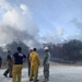 U.S. Navy Seabees with NMCB-5’s Detail Tinian help fight a local brushfire