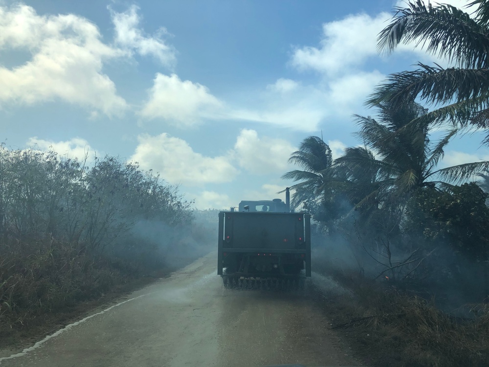 U.S. Navy Seabees with NMCB-5’s Detail Tinian help fight a local brushfire