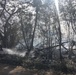 U.S. Navy Seabees with NMCB-5’s Detail Tinian help fight a local brushfire