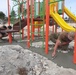 U.S. Navy Seabees with NMCB-5’s Detail Tinian install jungle gym at a children’s park