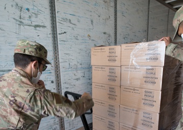 Members from the 150th Mission Support Group work to complete another food delivery mission in Santa Fe, N.M.