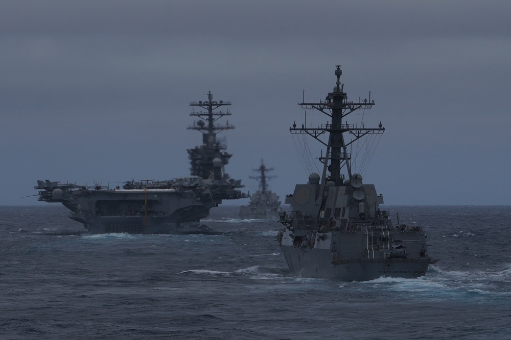 USS Ralph Johnson (DDG 114) and USS Sterret (DDG 104) transit the Pacific with aircraft carrier USS Nimitz (CVN 68)