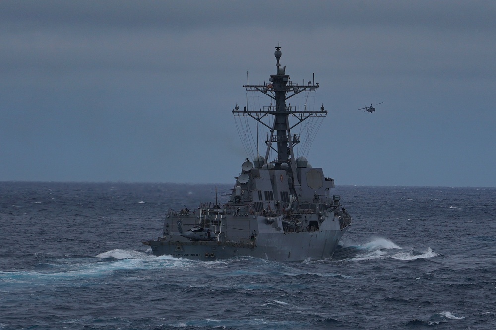 The Arleigh Burke-class guided-missile destroyer USS Ralph Johnson (DDG 114) transits the Pacific Ocean