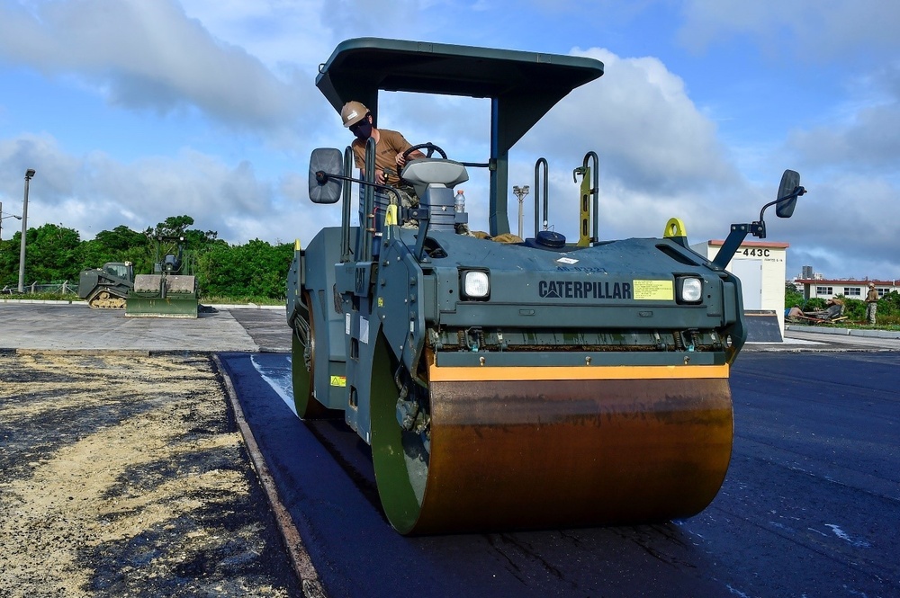 U.S. Navy Seabees with NMCB-5 place asphalt for Marine Air Control Squadron 4