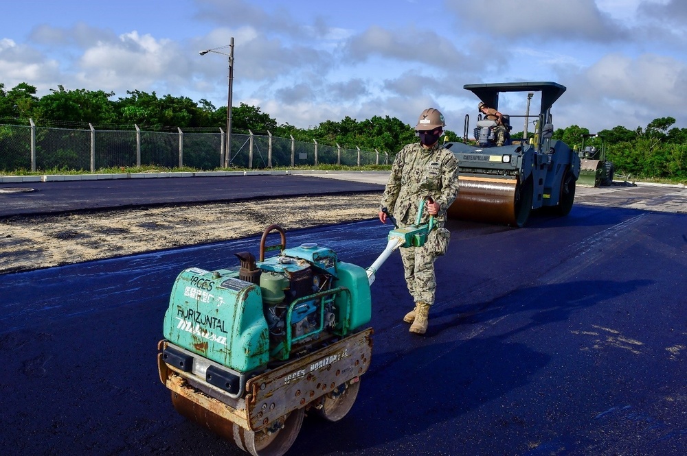 U.S. Navy Seabees with NMCB-5 place asphalt for Marine Air Control Squadron 4