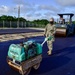 U.S. Navy Seabees with NMCB-5 place asphalt for Marine Air Control Squadron 4