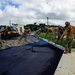 U.S. Navy Seabees with NMCB-5 place asphalt for Marine Air Control Squadron 4