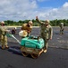 U.S. Navy Seabees with NMCB-5 place asphalt for Marine Air Control Squadron 4