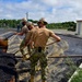 U.S. Navy Seabees with NMCB-5 place asphalt for Marine Air Control Squadron 4