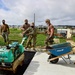 U.S. Navy Seabees with NMCB-5 place asphalt for Marine Air Control Squadron 4