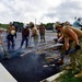U.S. Navy Seabees with NMCB-5 place asphalt for Marine Air Control Squadron 4