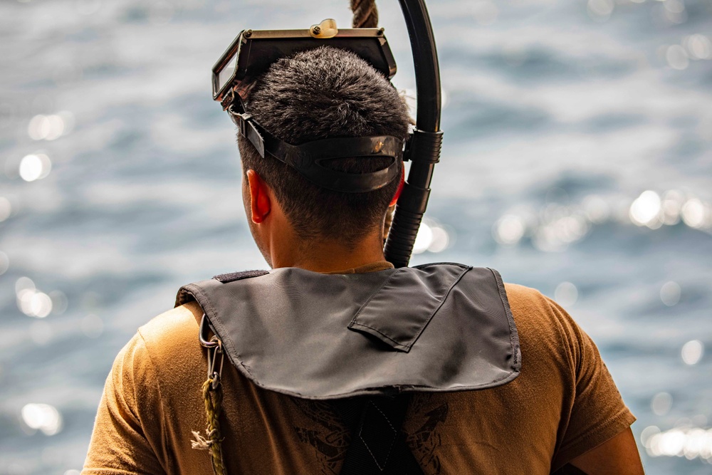 Sailors take part in a man overboard drill