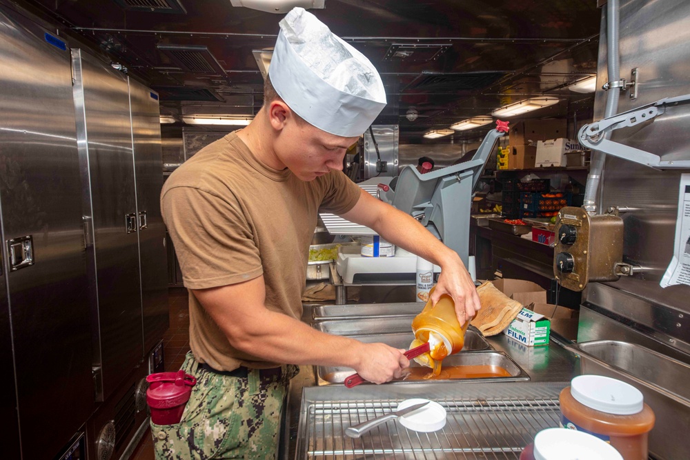 Sailors and Marines work in the galley