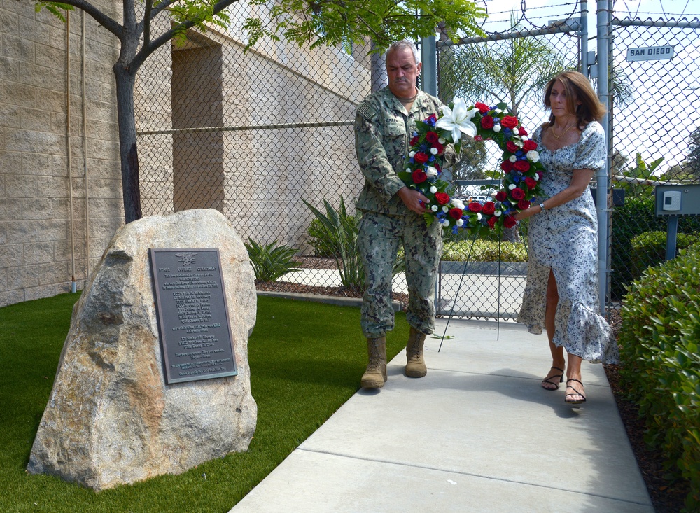 Rear Adm. Collin Green, commander, Naval Special Warfare Command (NSWC) and his wife Alyssa lay a wreath in observance of Memorial Day on the Gold Medallion Tree Memorial at NSWC Headquarters.