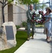 Rear Adm. Collin Green, commander, Naval Special Warfare Command (NSWC) and his wife Alyssa lay a wreath in observance of Memorial Day on the Gold Medallion Tree Memorial at NSWC Headquarters.