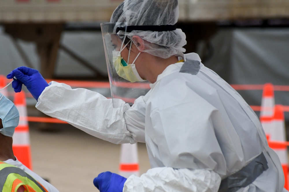 Members of the Texas Air and Army National Guard administer COVID-19 tests in Mount Pleasant, Texas
