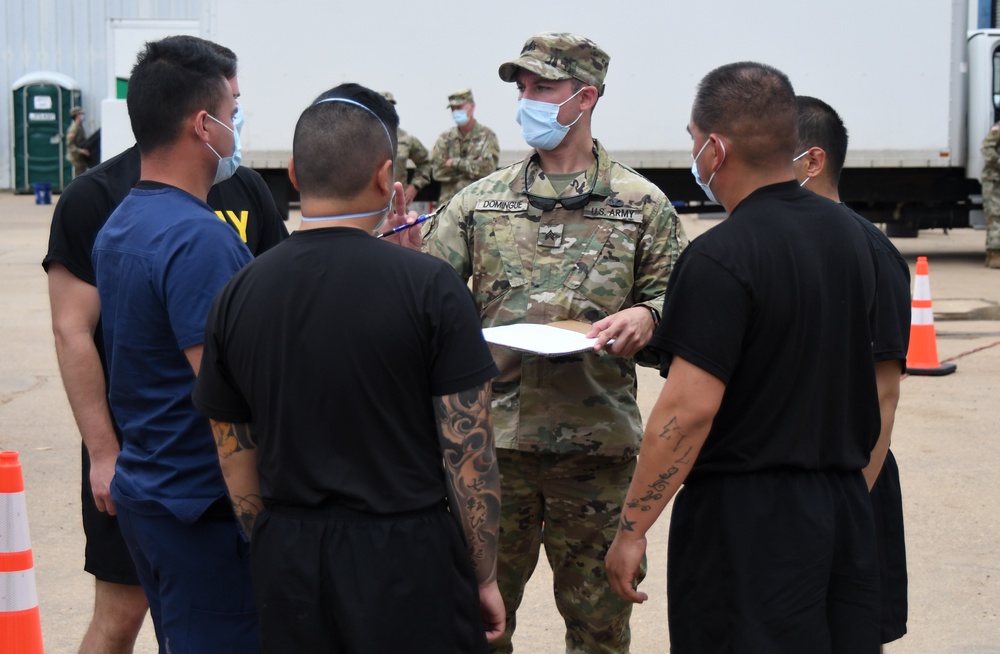 Members of the Texas Air and Army National Guard prepare to administer COVID-19 tests in Mount Pleasant, TX
