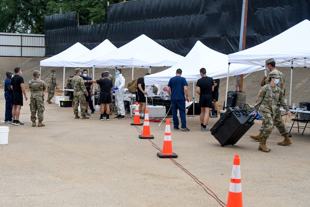Members of the Texas Air and Army National Guard prepare to administer COVID-19 tests in Mount Pleasant, Texas