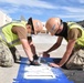 Seabees assigned to Naval Support Activity Souda Bay, Greece, Public Works Department, spray paint for a reserved parking space in the Navy Exchange parking lot