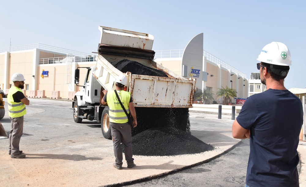 A truck dumps asphalt in the Navy Exchange parking lot on Naval Support Activity Souda Bay, Greece