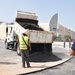A truck dumps asphalt in the Navy Exchange parking lot on Naval Support Activity Souda Bay, Greece