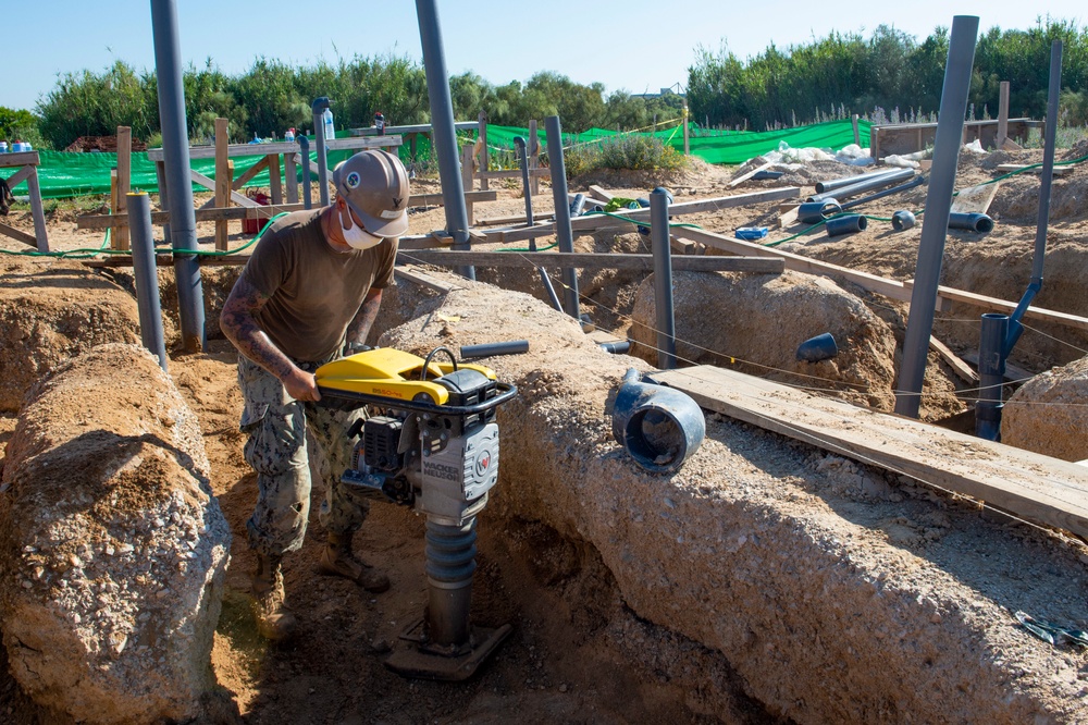 NMCB 1 Seabees install sewage lines for kennel office building project.