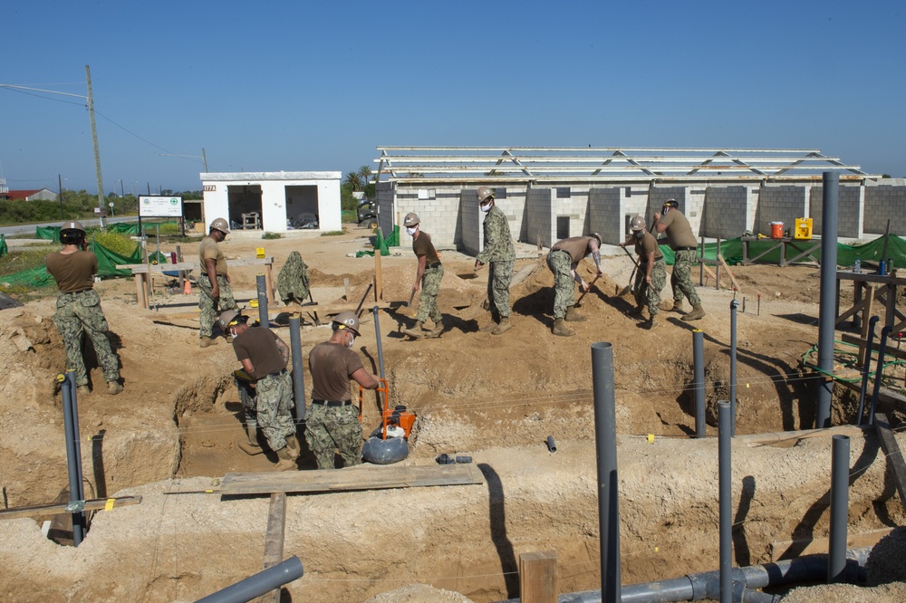 NMCB 1 Seabees install sewage lines for kennel office building project.