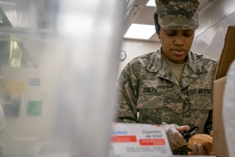 Services Airman Fills Plates and Spirits