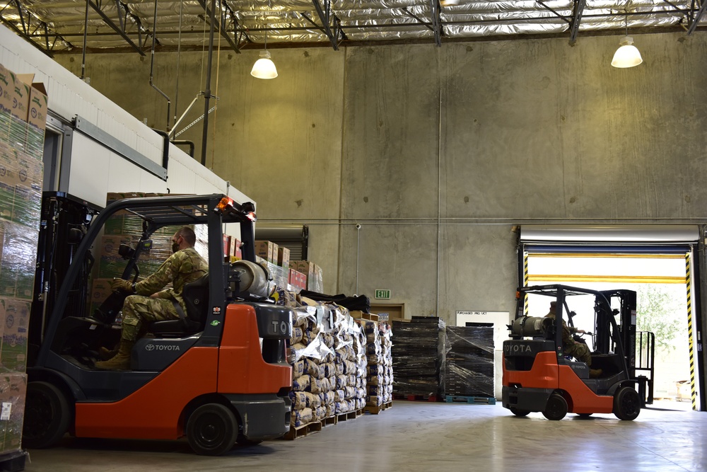 Soldiers with forklift certification aid FIND Food Bank warehouse mission