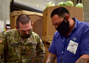 Soldiers with forklift certification aid FIND Food Bank warehouse mission