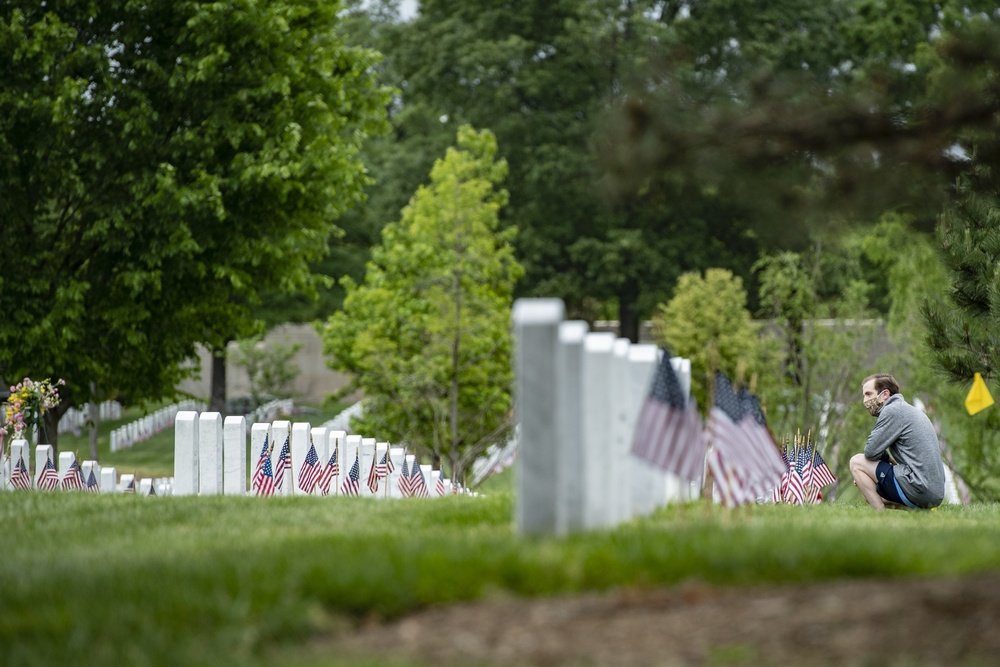 Over Memorial Day Weekend, family members visit gravesites of loved ones in Section 64 of Arlington National Cemetery, Arlington, Virginia, May 24, 2020. (U.S. Army photo by Elizabeth Fraser / Arlington National Cemetery / released)