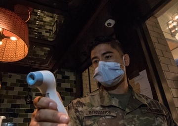 501st Medical Company Area Support checks an infrared thermometer in New York