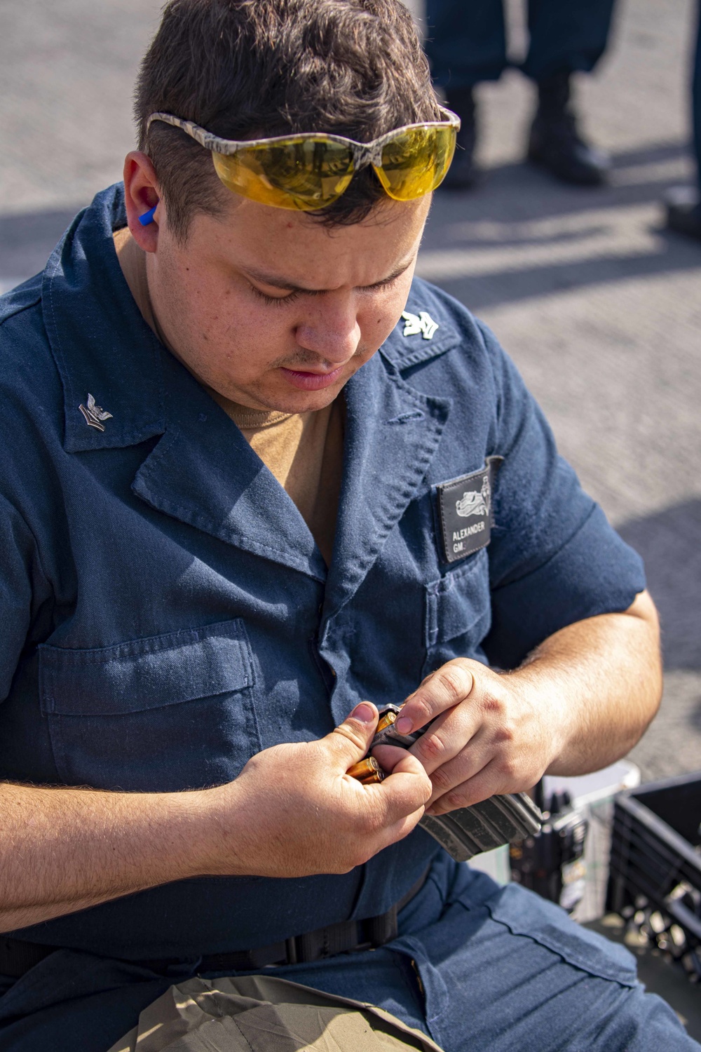 Sailors take part in a weapons qualification